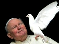 Pope John Paul II looks at a one of the two doves released by children from the window of his ...