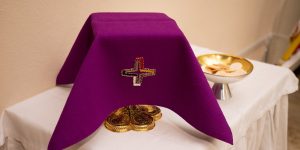 eucharist on a table purple cloth covering cupeucharist on a table purple cloth covering cup Christian Liebel unsplash Christian Liebel unsplash