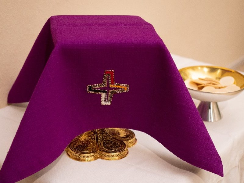 eucharist on a table purple cloth covering cupeucharist on a table purple cloth covering cup Christian Liebel unsplash Christian Liebel unsplash