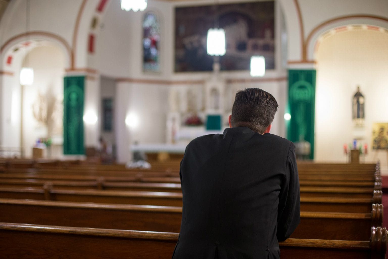 man praying in church