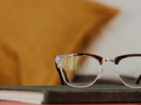 Closed books, glasses, yellow pillow 250x500