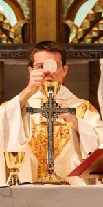 blessing the eucharist during mass masonry
