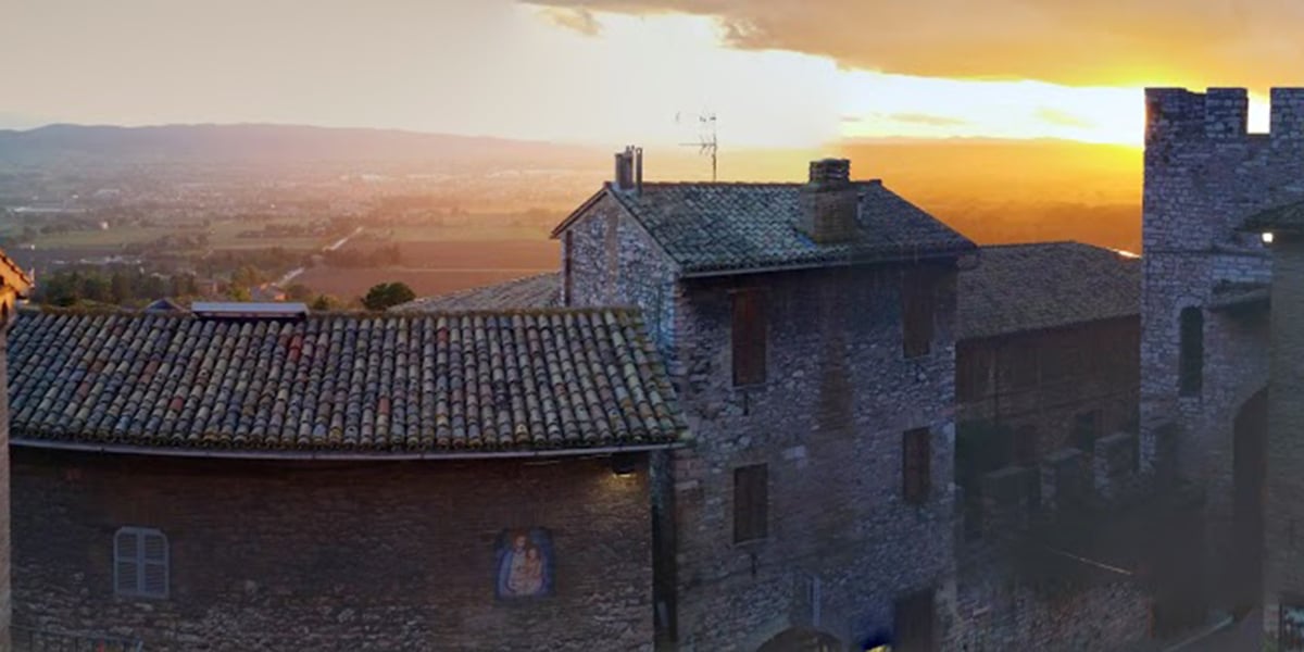 Saint Francis of Assisi sunset rooftops magical medieval town