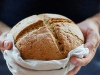 Bread loaf cross bun hands_kate-remmer-RZn4_FzNUCY-unsplash 1200 x 600